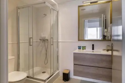 a bathroom with a shower and a toilet and a sink at Rainbow Sitges in Sitges