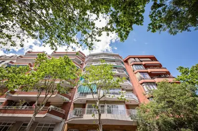 an apartment building with trees in the foreground at Sweett - Gaudi Avenue in Barcelona
