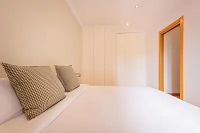 a bedroom with a white bed with two pillows at Sweett - Vicky Barcelona in Barcelona