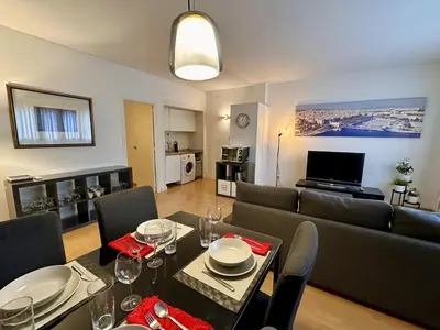 a living room with a couch and a table with chairs at Spacious home in Bonanova in Barcelona