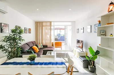 a living room with a couch and a table at AIGUADOLÇ APARTMENT in Sitges