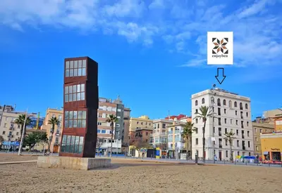 a view of a city with buildings and a sign at Beachfront apartment Barceloneta Street in Barcelona