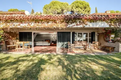 an outdoor patio with a table and chairs at Villa Exclusiva 12 Personas con Piscina, Barbacoa y Vistas al Mar en Maresme Barcelona in Sant Vicenç de Montalt
