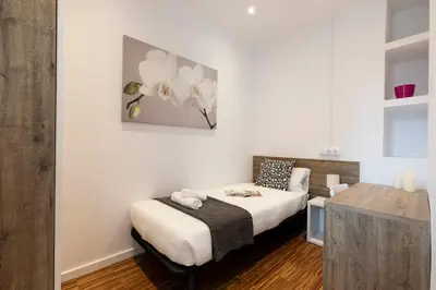a bedroom with a bed and a desk in it at 2905 - AB Comte dUrgell I-II in Barcelona