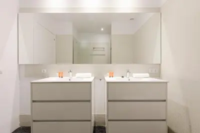 a bathroom with two sinks and a large mirror at 2905 - AB Comte dUrgell I-II in Barcelona
