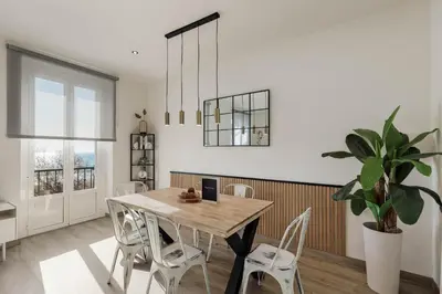 a dining room with a table and a potted plant at Sitges Group Beach Dreams in Sitges