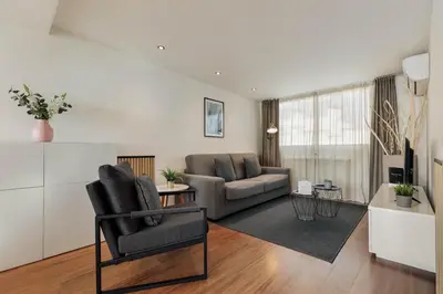 a living room with a couch and a table at Sitges Group Beach Dreams in Sitges