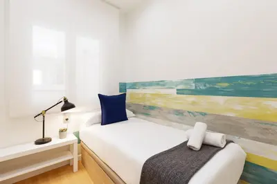 a bedroom with a bed and a painting on the wall at Sitges Group Beach Dreams in Sitges