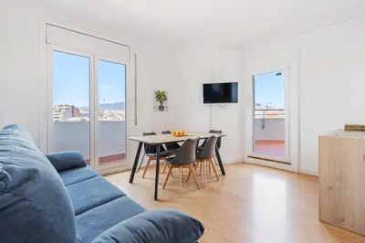 a living room with a blue couch and a table with chairs at 4151 - AB Sagrada Familia Views VII-II in Barcelona