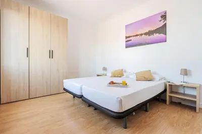 a white bedroom with a bed and a cabinet at 4151 - AB Sagrada Familia Views VII-II in Barcelona