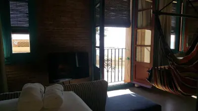 a view of a beach with palm trees and the ocean at Barcelona apartment with sea view in Barcelona