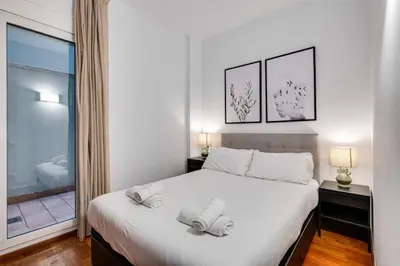 a bedroom with a bed with two towels on it at Acogedor apartamento en el corazón de Sant Antoni in Barcelona