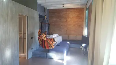 a room with a couch and a hanging hammock at Beach apartment with sea views in Barcelona