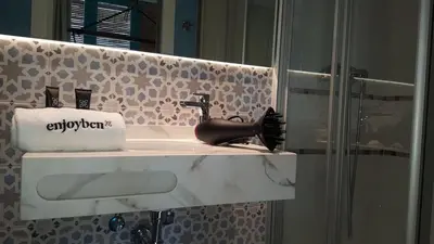 a bathroom with a sink and a mirror at Beach apartment with sea views in Barcelona