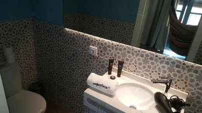 a bathroom with a sink and a toilet at Beach apartment with sea views in Barcelona