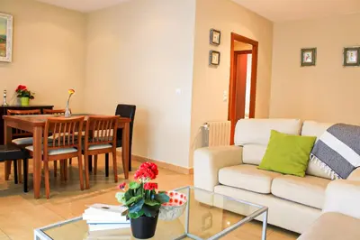 a living room with a couch and a table at Apartamento Sitges Can Robert in Sitges