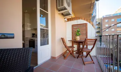 a balcony with a table and chairs on a balcony at Apartamento de cuatro dormitorios en Carrer Diputació in Barcelona