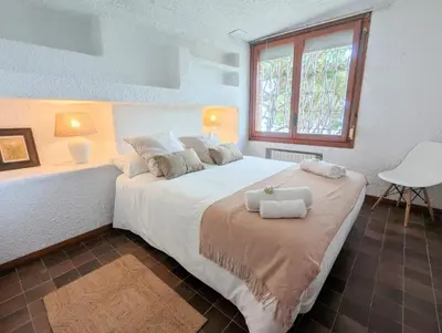 a bedroom with a large bed with towels on it at Villa Juny Best view in North Barcelona Coast in Cabrils