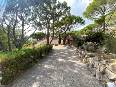 a driveway with a stone wall and a house at Villa Juny Best view in North Barcelona Coast in Cabrils