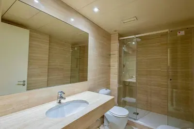 a bathroom with a sink and a toilet and a mirror at Apartment for 6, spacious and bright in Bonanova in Barcelona