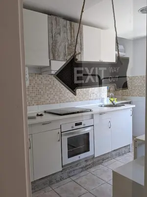 a kitchen with white cabinets and an oven at La CASA BLAVA in Cubelles