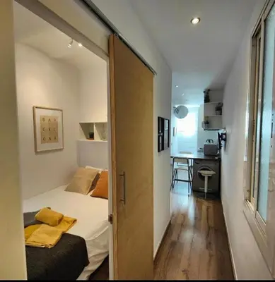 a small bedroom with a bed and a desk at Bright and cozy 2 rooms apartment in Hospitalet de Llobregat