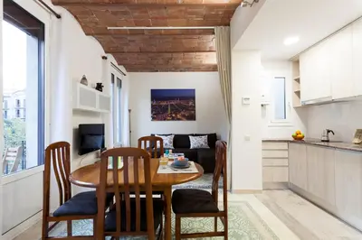 a kitchen and living room with a table and chairs at 2582 - AB Sagrada Familia Marina in Barcelona