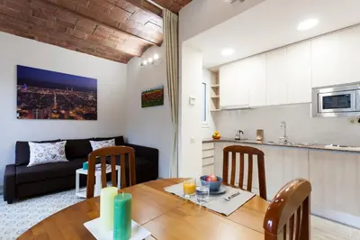 a kitchen and a living room with a table and chairs at 2582 - AB Sagrada Familia Marina in Barcelona