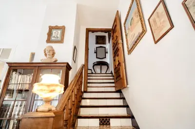 a staircase in a home with art on the walls at HomeHolidaysRentals Suria - Costa Barcelona in San Pol de Mar