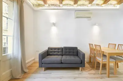 a living room with a blue couch and a table at Ro Lively and bright apartment next to Blai st in Barcelona