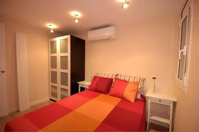 a bedroom with a colorful bed and a desk at Ramblas Rentals Central Duplex 4BR Terrace Pool Table & Ping Pong in Barcelona