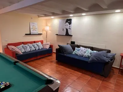 a living room with two couches and a pool table at Ramblas Rentals Central Duplex 4BR Terrace Pool Table & Ping Pong in Barcelona