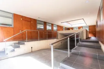 a staircase in a building with escalators and windows at Petit Luxe Mutua in Terrassa