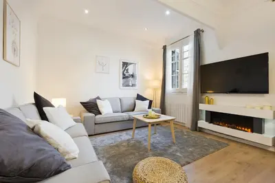 a living room with a couch and a tv at Barcelona Central Park II in Barcelona