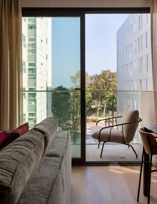a living room with a couch and a chair at Durlet Suites by Durlet Apartments in Barcelona