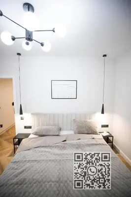 a bedroom with a large bed and two lamps at My White Vilanova Home in Vilanova i la Geltrú