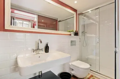 a bathroom with a sink and a toilet and a shower at Ola Living Arc de Triomf in Barcelona
