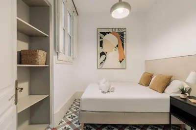 a bedroom with a bed and a closet at Ola Living Arc de Triomf in Barcelona