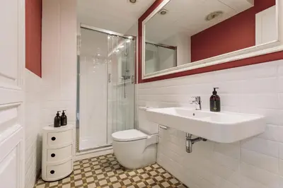 a bathroom with a toilet and a sink and a shower at Ola Living Arc de Triomf in Barcelona