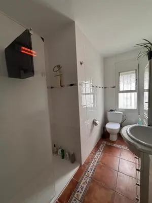 a bathroom with a shower and a toilet and a sink at Parc du Montnegre avec magnifique vue mer in Tordera