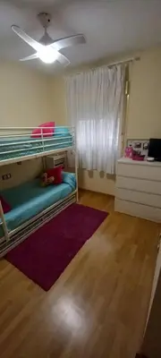 a bedroom with bunk beds and a ceiling fan at Piso in Hospitalet de Llobregat