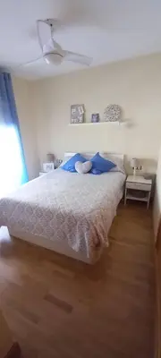 a bedroom with a large bed with blue pillows at Piso in Hospitalet de Llobregat