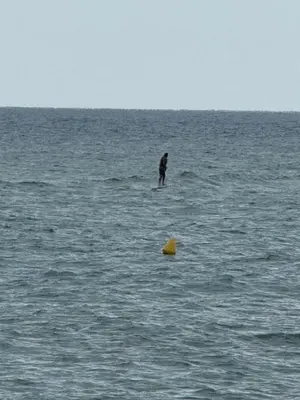 a person standing in the middle of the ocean at Casamar in Sant Vicenç de Montalt