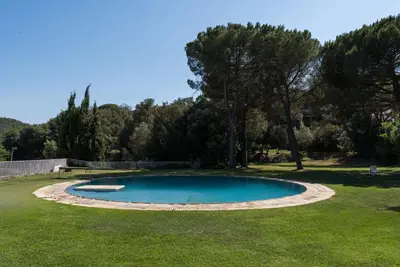 a small pool in a yard with grass and trees at Casakubrick mansión in Castelltersol