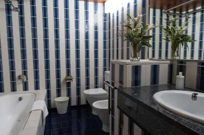 a bathroom with two toilets and a tub and a sink at Casakubrick mansión in Castelltersol