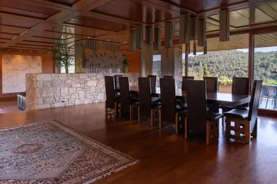 a dining room with a long table and chairs at Casakubrick mansión in Castelltersol