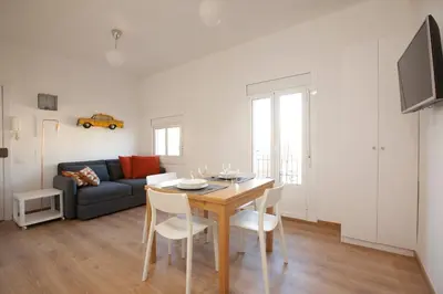 a living room with a table and a couch at Renovated apartment with sea view, VJ in Barcelona