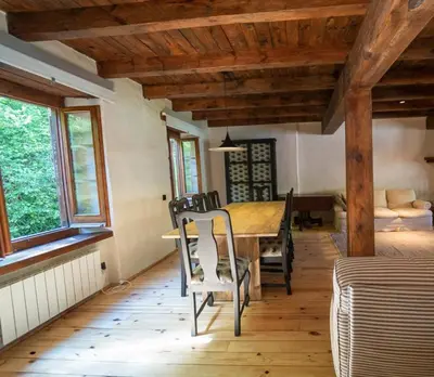 a dining room with a wooden table and chairs at Apartamento montaña en Arties in Artés