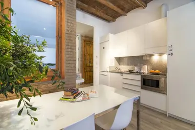 a kitchen with white cabinets and a white counter top at Happy People Sagrada Familia Apartments in Barcelona