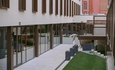 a hallway of a building with a green lawn at BLAU Student Housing - Students Only in Barcelona